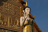 Vientiane, Laos - Pha That Luang, the elegant structure, Wat That Luang Neua, with a very ornate front faade fronted by two tall standing Buddha statues. 